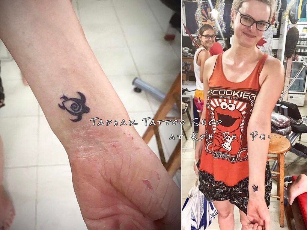 A symbolic turtle tattoo and a girl showing it off.