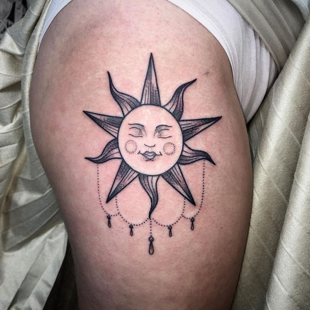A smiling sun tattoo