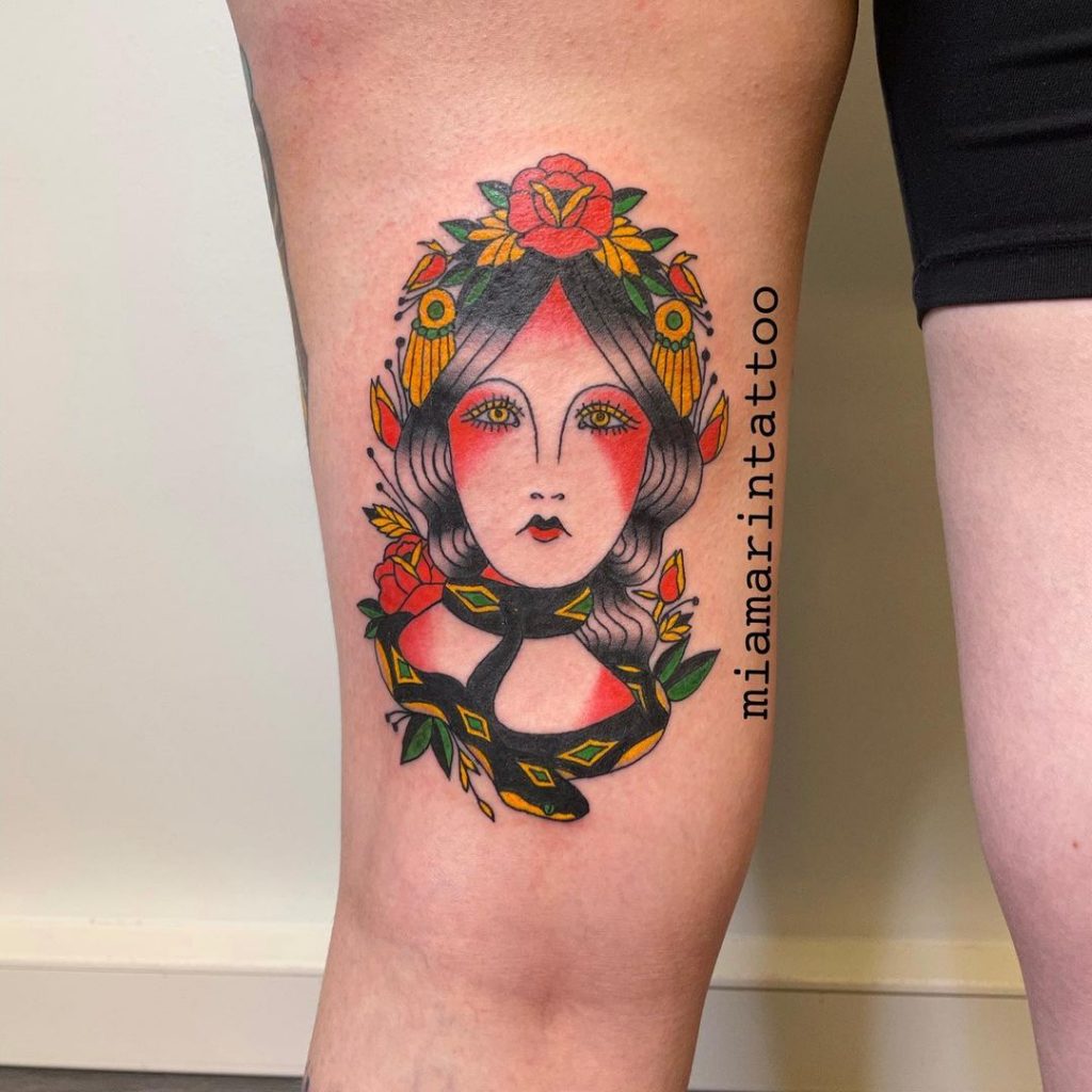 A serpent strangling a woman tattoo