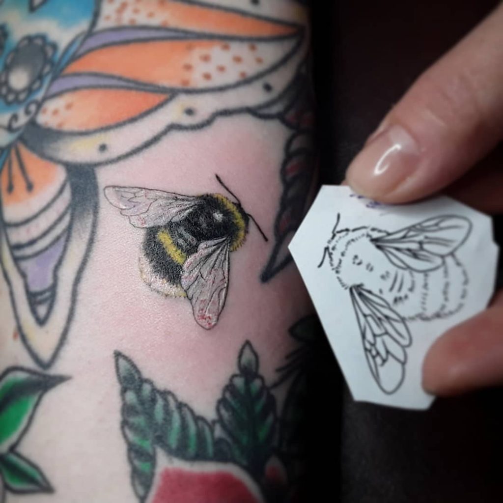 A bee small filler gap tattoo