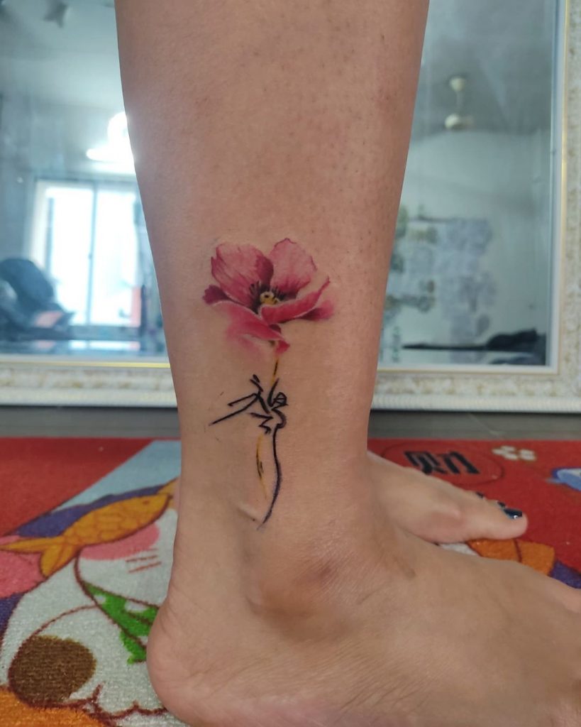 An artistic small leg tattoo for guys