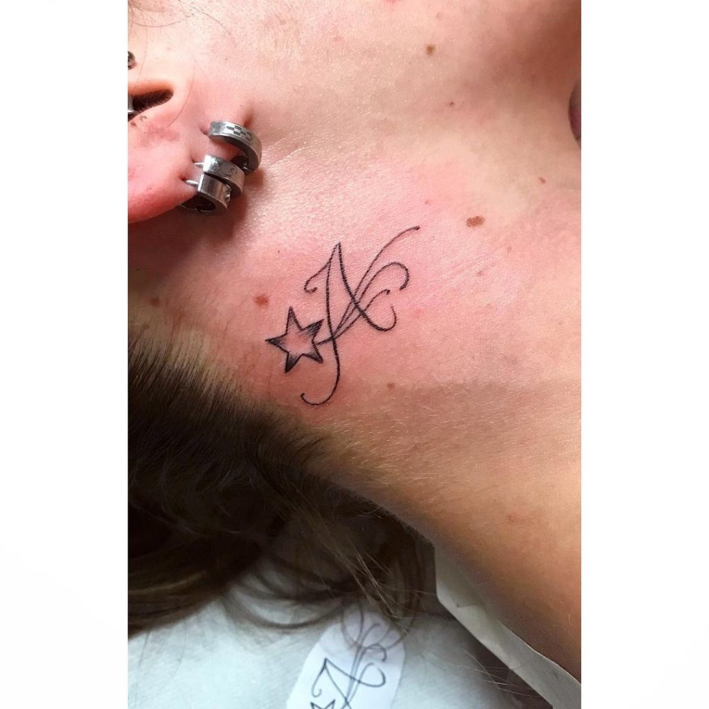 Star as a behind the ear tattoo