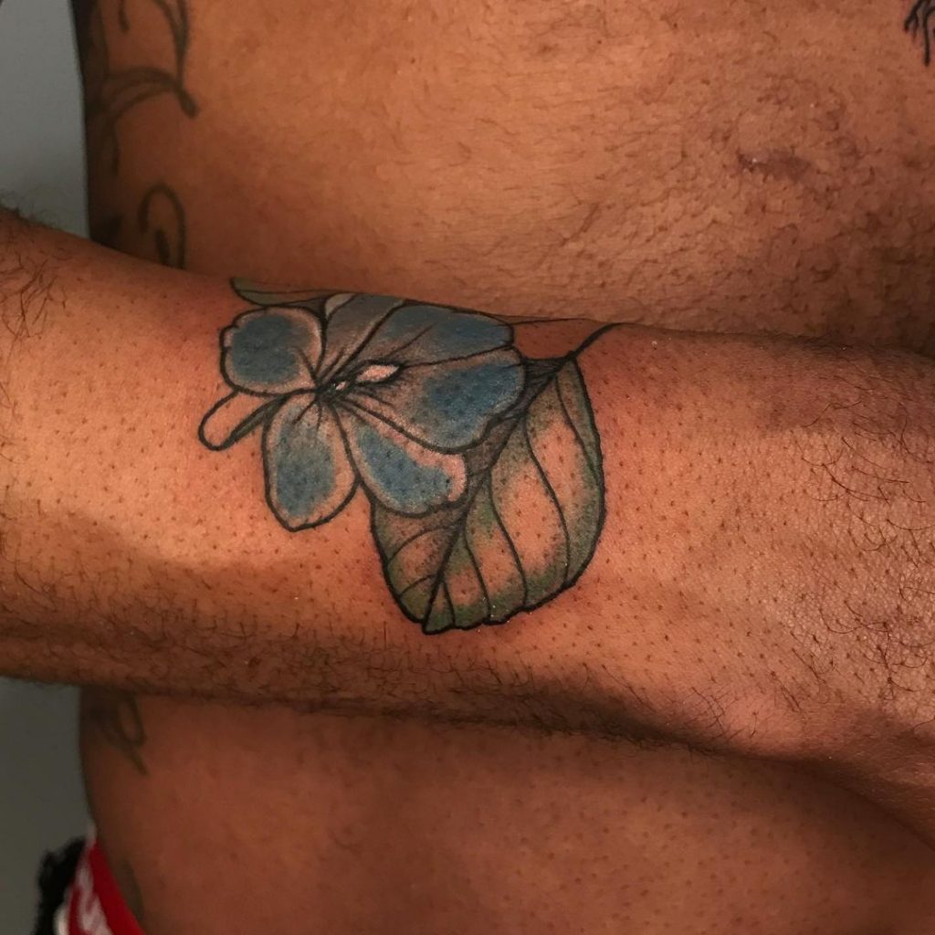 Blue color tattoos on dark skin