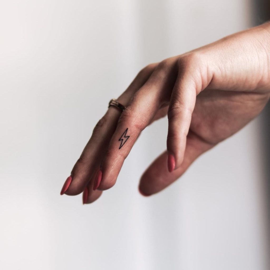 Lightning as small finger tattoos